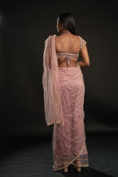 This dusty pink saree is a vision of elegance, crafted from Net fabric that glimmers with every movement. Paired with a Net blouse, the ensemble radiates sophistication and charm. The intricately hand-embroidered blouse adds a touch of glamour, making it perfect for a cocktail or reception, whether for the bride or her bridesmaids. With its timeless allure and delicate detailing, this saree is sure to captivate attention and leave a lasting impression on any special occasion.From Jigar & Nikita' Evening Chanderi Blouse Piece With Sheer Dupatta, Evening Chanderi Blouse Piece With Mirror Work, Pink Pre-draped Saree With Unstitched Blouse For Evening, Pink Floor-length Blouse Piece With Sheer Dupatta, Festive Organza Saree For Evening, Elegant Pink Chanderi Pre-draped Saree, Organza Saree With Pallu For Evening, Evening Organza Saree With Pallu Detail, Evening Lehenga With Mirror Work In Tissue Silk