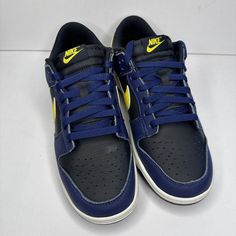 Elevate your sneaker game with the Nike Dunk Low "Vintage Michigan" Men's Shoe. This Nike Dunk Low features a low-top silhouette with a lace-up closure for a secure fit. The black/tour yellow/midnight navy/sail colorway is perfect for any occasion, whether it's activewear or casual wear. Made of high-quality materials, these sneakers are durable and will last you for years to come. The rubber outsole provides excellent traction and support, making them perfect for gym and training, walking, school, skateboarding, basketball, or bodybuilding. The Nike Dunk Low "Vintage Michigan" Men's Shoe is a must-have for sneaker enthusiasts who appreciate designer, colorful, outdoor, 80s, city, classic, 90s, retro, baroque, and hip hop themes. Add them to your collection today! Vintage Michigan, Men's Shoe, Sneaker Games, 90s Retro, Midnight Navy, Nike Dunk Low, Dunk Low, Nike Dunk, Nike Dunks