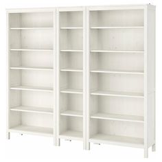 two white bookcases sitting next to each other on top of a white floor