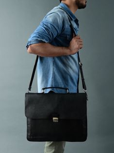 Our Sleek Black Attache Laptop Bag combines style with functionality. Crafted from robust buffalo leather, it exudes durability and sophistication. The metal clasp closure ensures secure storage, while the canvas lining adds sturdiness. There's a large main compartment along with other small compartments for keeping your belongings organized. With ample space, it comfortably accommodates a laptop, books, and files, making it perfect for office meetings or offsite outings. Elevate your profession Everyday Rectangular Briefcase With Hasp Closure, Business Flap Shoulder Bag With Hasp Closure, Business Shoulder Bag With Flap Hasp Closure, Flap Shoulder Bag With Hasp Closure For Business, Business Shoulder Bag With Flap And Hasp Closure, Formal Satchel Shoulder Bag With Gunmetal Hardware, Classic Travel Flap Bag With Top Carry Handle, Classic Saddle Bag With Hasp Closure For Everyday Use, Classic Saddle Bag With Hasp Closure For Travel