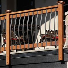 an iron and wood balcony railing on a building