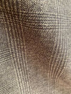 close up view of the texture of a brown and white checkered suiting material