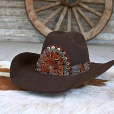 The Rowan Western Feather Hat Band, Short, is specially crafted for smaller-sized hats (6 7/8 and under) and kids' hats. Made from 100% feather, it has an approximate length of 53 cm (excluding leather ties) and a width of 2 cm. The crest measures 4" W x 3.25" H, adding a distinctive and elegant touch to the design. Adjustable with leather ties, this hat band ensures a secure fit while providing a stylish western accent for smaller hats. Rustic Adjustable Brown Top Hat, Brown Curved Brim Hat Bands For Kentucky Derby, Southern Style Brown Hat Bands For Rodeo, Southern Style Brown Hat Band For Rodeo, Brown Curved Brim Top Hat For Ranch, Adjustable Brown Mini Hat With Short Brim, Brown Adjustable Mini Hat With Short Brim, Brown Curved Brim Top Hat For Kentucky Derby, Adjustable Brown Top Hat For Ranch