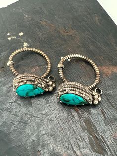 This exquisite earring is a stunning piece of traditional Tibetan jewelry handcrafted entirely by skilled artisans. This intricate design features turquoise set in Tibetan silver show casing the unique and beautiful culture of Tibet and Nepal Artisan Turquoise Jewelry With Matching Earrings, Unique Festive Drop Earrings, Ceremonial Chandbali Jewelry For Pierced Ears, Ceremonial Chandbali Pierced Jewelry, Traditional Metal Drop Earrings, Bohemian Turquoise Earrings With Intricate Design, Turquoise Dangle Jewelry For Festivals, Turquoise Bohemian Earrings With Intricate Design, Artisan Jewelry With Oxidized Finish For Festivals