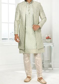 Readymade Art Silk Sherwani, and Jacket. Art Dupion Aligarhi Ready Made Trouser. Resham, Sequences, and Zari Work. Crafted in Chinese Collar Neck, and Full Sleeve. Faux Satin Lining with Plain Work. High-Quality Matching Buttons. Please Note: The footwear shown in the picture is for presentation and photography purpose only. Color: There might be slight color variation due to lightings and flashes while photo shooting. The color may also vary because of different screen resolutions. Wash Care: D Designer Front Open Kurta With Cutdana, Fitted Nehru Jacket With Naqshi Straight Kurta, Fitted Nehru Jacket With Naqshi In Straight Kurta Style, Pista Green Kurta With Naqshi Traditional Drape, Pista Green Kurta With Naqshi In Traditional Style, Festive Pista Green Kurta With Naqshi, Festive Pista Green Straight Kurta Bandhgala, Elegant Pista Green Bandhgala For Eid, Festive Pista Green Nehru Jacket For Designer Wear