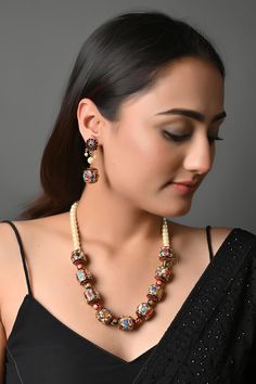 Pearls and Multicoloured Semi Precious Stones Jadau Meenakari Work Necklace With Earrings, Designer Indian Jewelry, Party Wear Necklace Multicolored Jadau stone work pearl necklace. This beautifully handcrafted necklace is set in copper alloy and plated with 22k gold. It will go with everything and make your outfit super chic. Perfect to wear to gala dinner, and perfect gift for family members, friends, or bridesmaids. PRODUCT DETAIL: * Necklace Length: 18 inches (comes with adjustable Lock) * Earrings Length: 1.5 inches approx * Material: Pearl, brass, and stone STYLE TIP: This necklace is a perfect accessory for Simple Indo western dresses or pastel ethnic attire. This necklace is a go-to accessory for chiffon sarees or georgette lehengas.  ABOUT US: Jaipri makes each piece of its produc Elegant Multicolor Jewelry Sets For Diwali, Multicolor Beaded Bridal Necklace For Party, Festive White Necklace With Colorful Beads, Elegant Multicolor Kundan Necklace For Celebrations, Multicolor Round Beads Jewelry Sets For Celebration, Elegant Multicolor Jewelry Sets With Latkans, Multicolor Round Beads Pearl Necklace For Parties, Elegant Multicolor Jewelry For Diwali, Elegant Multicolor Temple Necklace For Celebration