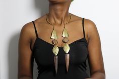 African Brass and cowrie necklace, African necklace with matching earrings, Brass jewelry, Women jewelry, Christmas Gift for her The necklace is handcrafted using brass metal and cowrie decorations. Neck size: 35 cm (adjustable and can fit any neck size)  Pendant Length: 30 cm Shipping fee is for the first item only, additional items ship for FREE. DHL Express shipping with 3-5 days delivery. To view our brass collection, click here: nkoroicrafts.etsy.com *Care instructions* Brass tarnishes with exposure to moisture and oxidation. To clean it, kindly use a lemon wedge. Squeeze the juice and polish along the surface with a clean cloth. African Metal Jewelry, Traditional Brown Brass Jewelry, Bohemian Brass Jewelry With Fair Trade Details, Bohemian Brass Jewelry Fair Trade, Bohemian Fair Trade Brass Jewelry, Unique Brown Brass Jewelry, Cowrie Necklace, African Inspired Jewelry, Necklace African