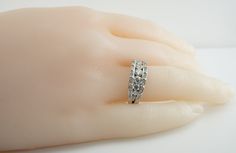 Genuine Diamond Ring, April Birthstone, Vintage Ring, 14K White Gold Band, Gold Ring, Natural Diamond Band, Engagement Ring, Wedding Ring, This adorable estate ring is crafted in solid 14K White Gold. 9 center round brilliant cut diamonds graduate in size and total 1.07 carats. They are VS2-SI2 clarity and H color. 32 smaller diamonds total .32 carat of SI1 clarity and HI color. The total diamond weight for the ring is 1.39 carats. The top measures 7mm North-South. Size 7 (sizable). The ring wei Channel Set Moissanite Diamond Ring For Anniversary, Moissanite Diamond Ring With Channel Set For Anniversary, Wedding Cluster Ring With Single Cut Diamonds, Diamond White Round Cut Diamond Ring For Marriage, Channel Set Round Cut Diamond Wedding Ring, Channel Set Emerald Cut Diamond Ring For Wedding, Channel Set Round Ring For Anniversary, 14k White Gold Vvs Clarity Diamond Ring For Anniversary, 14k White Gold Channel Set Rings For Anniversary