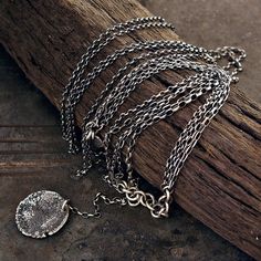 "long multi-strand necklace handmade of oxidized 925 sterling silver, signed, © ewa lompe APPROXIMATE MEASUREMENTS: raw hammered disc size: ~ 22mm chains size: 80 cm or 31.5 \" raw disc + chain size: 8 cm or 3.2\" necklace size: 88 cm or 35\" The item pictured is not the exact ones that you will receive, but it will be the same design. The matching earrings are here: https://www.etsy.com/listing/613432669/use-codes-sale-10-15-20-off-sequins-raw?ref=shop_home_active_14 and here: https://www.etsy. Sterling Silver Multi-strand Jewelry With Adjustable Chain, Sterling Silver Multi-strand Adjustable Chain Necklace, Silver Coin Pendant Jewelry For Layering, Silver Multi-strand Oxidized Jewelry, Artisan Double Strand Silver Necklaces, Artisan Silver Double Strand Necklace, Bohemian Sterling Silver Chain Necklace, Artisan Double Strand Silver Necklace, Silver Pendant Chain Necklace For Layering