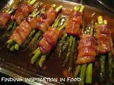 asparagus wrapped in bacon sitting on top of a baking sheet with the words finding inspiration in food