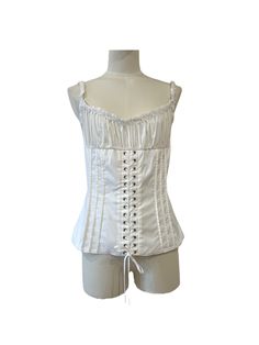 White cotton bustier top. Curling on the bust and laces on the front. Functional opening on the back with zip. Small lace border on the neckline and straps. Condition Details New with tag Size and Material 44 IT | L Fitted Cami Corset With Lace Trim, White Overbust Corset For Spring, White Corset With Built-in Bra And Tank Straps, White Boned Bodice Corset For Spring, White Lace Top Corset, White Lace Tops With Boned Bodice, White Lace Top With Boned Bodice, Sleeveless Lace Top With Corset Back, Fitted Corset With Lace Top And Spaghetti Straps