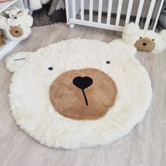 a teddy bear rug is on the floor next to other stuffed animals in a crib