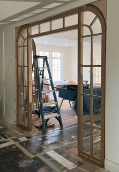 an open doorway with a ladder in the middle