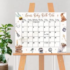 an easel with a calendar on it and a potted plant next to it