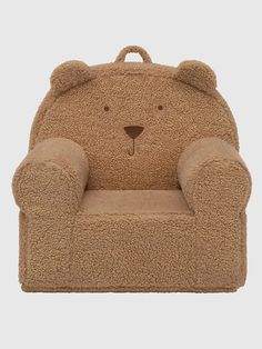 a brown teddy bear chair sitting on top of a white floor