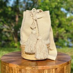 a white purse sitting on top of a wooden table