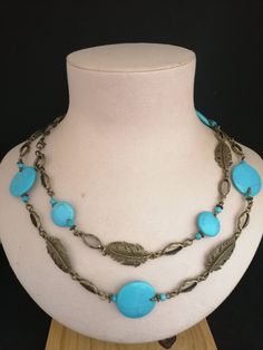 "Details *Handmade items  *Dispatches from a small business in Australia  *Materials: Gemstones, Bronze Fittings  *Gemstone: Turquoise  * Long Necklace: 42\" or 106 cm  * Closure: Lobster clasp  *Chain style: Bead  This gorgeous blue turquoise necklace never goes unnoticed. It features 25, 15 and 4 mm round turquoise stones. Set in bronze, and beautiful filigree leaf sharm are perfect suited with blue stones. This necklace measures 106 cm long. All the beads are individually treaded on antique Bronze pins and dressed in antique brass leaves connectors to give necklace perfect looking.  This turquoise beaded Necklace would be a perfect accessory to add a touch of color to any outfit. The stunning combination blue turquoise stones and bronze give it unique. Complete your look with a turquois Artisan Turquoise Jewelry With Beaded Chain, Artisan Turquoise Beaded Necklaces For Crafting, Turquoise Long Necklace For Jewelry Making, Long Turquoise Necklace For Jewelry Making, Festival Turquoise Beaded Chain Necklace, Turquoise Beaded Costume Jewelry Necklace, Costume Jewelry Turquoise Beaded Necklace, Handmade Adjustable Blue Turquoise Necklace, Artisan Turquoise Beaded Chain Necklace