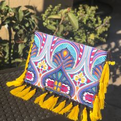 This Handbag Is Perfect For Those With A Strong Appreciation For Boho Chic. This Clutch Bag Is A Handcrafted Thai Handbag That Features An Embroidered Tribal Pattern Black Cotton Lining, Adorned With Tassels.This Clutch Is Sure To Ensure A Night Of Fun! Bohemian Tassel Clutch Bag, Traditional Tassel Pouch Bag, Traditional Pouch Bag With Tassels, Bohemian Clutch Bag With Tassels, Rectangular Clutch With Tassels For Daily Use, Multicolor Tassel Pouch Bag, Bohemian Rectangular Clutch With Tassels, Rectangular Bags With Multicolor Embroidery And Tassels, Vacation Tassel Clutch Bags