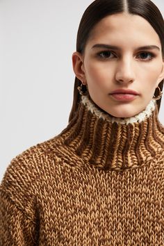 Designed for the coldest months, this turtleneck sweater is crafted from a wool blend that guarantees ultimate warmth without feeling heavy. The heavy knit moves effortlessly from the city to the chalet. Wool High Neck Sweater With Ribbed Cuffs, Winter Wool Turtleneck With Knit Fabrication, Winter Wool Knit Turtleneck, Wool Turtleneck With Knit Fabrication For Winter, Wool Knit Turtleneck For Winter, Winter Merino Wool Turtleneck With Ribbed Cuffs, Merino Wool Turtleneck With Ribbed Cuffs For Winter, Cozy Brown Turtleneck, Luxury Brown Wool Sweater