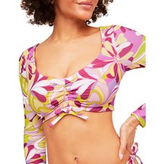 Topaz's print is so fun and unique, you'll want it on everything! This long-sleeve swim top is the perfect addition to your summer swim collection. The open-back design and functional ruching front help keep you in place and looking good. Multicolor Graphic Print Swimwear For Spring, Casual Pink Tops For Pool, Poolside Stretch Printed Tops, Printed Stretch Tops For Poolside, Stretch Printed Tops For Poolside, Stretch Printed Tops For Beachwear, Floral Print Beachwear Tops For Pool, Fitted Graphic Print Swimwear For Spring, Long Sleeve Swimwear With Upf 50+ For Spring