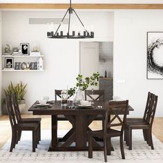 a dining room table and chairs in front of a white wall