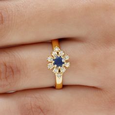 Product Details An Attractive and Shimmering Flower Gold Ring is adorned with Solitaire 4.00 MM Round Shape Blue Sapphire is beautifully studded in beautiful floral design and Small Round Shape Diamond engraved on the petal in pave setting. Flower Cluster Ring is crafted in Gold. An ideal Jewelry Wedding Collection for bridal. Product Information SKU SHP-RINGS122041624 Width 6.8 mm Height 9 mm Weight 4.08 gm (Approximate) BLUE SAPPHIRE INFORMATION No.of Stones 1 Pieces Total Weight 0.40 Carat (A Flower Cluster, Wedding Jewellery Collection, Pave Setting, Cluster Ring, Promise Rings, Round Shape, Blue Sapphire, Gold Rings, Floral Design