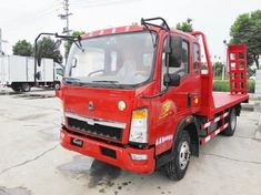 a red truck parked in a parking lot