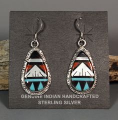 These gorgeous earrings are made by Zuni artists Leslie and Glady's Lamy. All the stone, shell and coral pieces were hand shaped and pieced together then set into a hand made sterling silver settings. Many years of experience and a LOT of time went into these. Leslie and Glady's specialize in these mosaic inlay pieces. You don't see many earrings. They mostly make pendants, bolos and rings. Signed and stamped sterling on the back of each earring. These are approx. 1-13/16" long including the ear wire and 11/16" wide Southwestern Oval Earrings As Gift, Southwestern Oval Earrings For Gift, Sterling Silver Teardrop Jewelry With Artistic Design, Artisan Teardrop Earrings With Artistic Design, Handmade Southwestern Oval Earrings, Artisan Jewelry With Matching Earrings For Collectors, Artisan Teardrop Jewelry For Collectors, Artisan Collectible Jewelry With Matching Earrings, Elegant Drop Earrings With Inlay