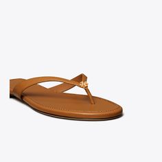 The warm-weather must have is elevated in rich leather with slim straps and a brass logo charm. A cushioned footbed ensures long-lasting comfort.Crafted in partnership with a Leather Working Group-certified tannery, supporting high standards in leather manufacturing and chemical management. Best Flip Flops, Jelly Slides, Carmel Color, Soft Sandals, Miller Sandal, Platform Flip Flops, Square Toe Sandals, Summer Flip Flops, Cute Sandals