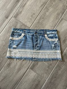 This screams Summer romance.  It's sassy, it's pretty & flirty.  Light and easy skirt to wear on the go or to that special event, Summer concert or festivals.  Pair it with a cowboy hat and boots.  Show off your legs with this mini-skirt.  It's unique, one of a kind Jean skirt Fitted Denim Skirt With Frayed Hem For Summer, Fitted Mini Length Jean Shorts With Frayed Hem, Fitted Mid-rise Summer Mini Skirt, Fitted Mid-rise Mini Skirt For Summer, Summer Fitted Cutoff Denim Skirt, Fitted Cutoff Denim Skirt For Summer, Bohemian Mini Denim Skirt, Fitted Cutoff Skort For Summer, Cotton Mini Bottoms With Lace Trim