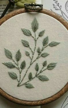 a close up of a embroidery on a wooden hoop