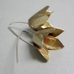 These statement earrings are made of brass, a bluebell flower just a little bit open, and a long stem in silver. The style is modern, minimal, and clean, and the manual cut adds value to every single pair, they follow the trend of fashion that wants big and showy earrings. Despite the dimensions are very light and very pleasant to wear even every day They weigh each 0.15 oz A total length of 2 " Maximum width of 1". Thank you for the visit, follow me on Instagram; @Petrahjewelry come on Facebook