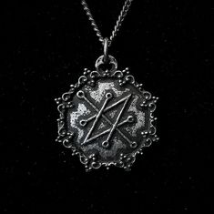 The Azazel Seal Pendant with Gothic Frame is a handcrafted piece made from fine pewter, containing 98% tin, featuring a detailed design that showcases the Seal of Azazel. This pendant measures 2.5 cm in diameter and is available with a choice of a stainless steel chain in either 18 or 24 inches, ensuring durability and hypoallergenic properties. With an antique finish, this pendant presents a textured appearance that gives it the look of an ancient artifact, enhancing its character and significa Azazel Sigil, Gothic Frame, Satanic Jewelry, Saturn Pendant, Gothic Culture, Personal Empowerment, Ancient Symbols, Ancient Artifacts, Antique Finish