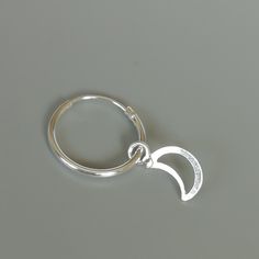 A PAIR of sterling silver hoops. Comes with a detachable cut out crescent moon charm. The charm is multipurpose and can be used with a neck or bracelet chain too. Dimension: Hoop- 15 x 1.5 mm Charm: 6 x 12 mm Drop length- 23 mm These earrings are made of 925 hypoallergenic sterling silver and plastic. Please note this price is for ONE PAIR. All my pieces are sent in a gift box. I can include a personal message from you if needed You are welcome to contact me at... bhavnakwintra1956@gmail.com For Adjustable Nickel-free Celestial Hoop Earrings, Adjustable Silver Celestial Hoop Earrings, Celestial Small Hoop Nickel-free Jewelry, Celestial Style Small Hoop Nickel-free Jewelry, Nickel-free Celestial Silver Hoop Earrings, Celestial Silver Hoop Earrings Hypoallergenic, Celestial Nickel-free Silver Hoop Earrings, Silver Crescent Cartilage Earrings With Moon Charm, Silver Moon-shaped Metal Hoop Earrings