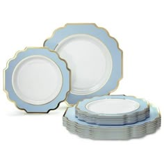 blue and white dinnerware set with gold trimmings on the rim, including plates