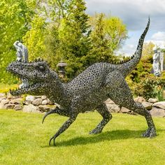 They may be extinct but they'll never be forgotten. Show-off this season and be the talk of the town with "Chompers" , our GIANT Metal Tyrannosaurus Rex Garden Statue. This beautifully constructed statue features an ornate iron crafted frame and a hand painted metallic black-bronze finish. He is freestanding but comes with metal stakes for added stability, especially one windy days. He makes a huge impact when displayed in front of your business, attracting potential customers with his attention Outdoor Statues Sculpture, Iron Straps, Metal Sculptures Garden, Garden Junk, Metal Sculptures, 3d Sculpture, Garden Statue, Outdoor Statues, Tyrannosaurus Rex