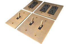 three switch plates with screws are shown in four different sizes and shapes, one is black and the other is gold