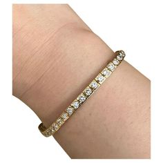 Round Diamond Tennis Line Bracelet 5.00 Carat Total Weight in 18k Yellow Gold Diamond Tennis Bracelet features one row of 47 Round Brilliant Diamonds that are set flush in a half bezel setting in 18k Yellow Gold. The bracelet is secured by a tongue clasp with safety. Total diamond weight is 5.00 carats. Bracelet measures 7 inches long and .15 inch wide. Bracelet weighs 16.9 grams. Set in 18k Yellow Gold. Marked 18k BUY WITH CONFIDENCE Authenticity is guaranteed for every item we sell. Luxury Tennis Bracelet With Channel Set For Formal Occasions, Luxury Channel Set Tennis Bracelet For Formal Occasions, Luxury Gold Channel Set Bracelet, Luxury Gold Bracelets With Channel Set, Timeless Channel Set Tennis Bracelet For Anniversary, Formal Yellow Gold Tennis Bracelet Channel Set, Formal Yellow Gold Channel Set Tennis Bracelet, Classic Yellow Gold Diamond Bracelet Channel Set, Classic Yellow Gold Diamond Bracelet With Channel Set