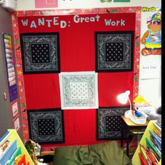 a bulletin board is decorated with black and red squares in the center, which reads wanted great work