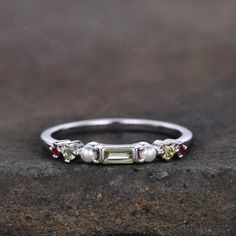 This is a unique vintage peridot and pearl ring in 925 sterling silver. Stone size: 4x2mm baguette cut Peridot + Pearl + Garnet This ring is marked S925/G10K/G14K I accept custom making order.Please contact me if you need this service. All the jewelry in my store is handmade.It may take 3-4 weeks to finish. I accept custom making order.Please contact me if you need this service. For all the jewelries,there is a 14 days money back guarantee.You can return it in the time frame without any question Heirloom Multi-stone Pearl Ring For Anniversary, Silver Birthstone Ring With Peridot And Accent Stones, Sterling Silver Multi-stone Stackable Wedding Rings, Sterling Silver Multi-stone Stackable Rings For Wedding, Heirloom Multi-stone Pearl Ring As Gift, Silver Ring With Peridot Birthstone, Heirloom Multi-stone Pearl Ring Gift, Rainbow Wedding Band, Peridot Multi-stone Rings For May Birthstone