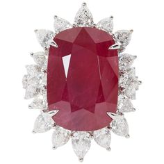 A rare find! Certified 24.64 carat cushion cut African Ruby with "intense red" color. The ruby is surrounded by 4.57 carats of pear shape diamonds. 18k Approximately 1.30 inches from its highest to lowest point, an inch wide. The ring is currently a size 7 but can easily be resized. Certified by C Dunaigre of Switzerland. A beautiful ruby ring! Luxury Jewelry Collection, Antique Ruby Ring, Vintage Cocktail Rings, Necklace Ruby, Ruby And Diamond Ring, Ruby Rings, Pear Ring, Ring Ruby, Woman Jewelry