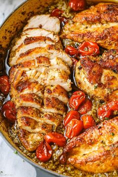 chicken and tomatoes in a skillet with seasoning