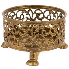 an ornately designed brass candle holder on a white background