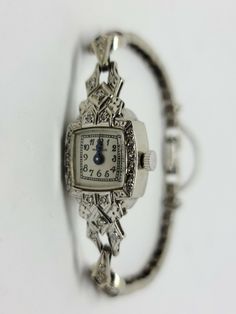 14K White Gold Vintage MAYFAIR Diamond Wrist Watch 6.5" inches with a 3" Safety Chain Beautiful Vintage Look with White Dial and Black Arabic Numbers and Blue Steel Hands. 65 Round diamonds for a total of 0.30 carats and a total weight of 12.84 Grams Includes GAL Appraisal MSRP $3,200 Condition is "Pre-owned" and in working condition with some signs of wear and stretch Shipped Free with USPS Priority Mail Time Waits For No One, Pretty Watches, Arabic Numbers, Fancy Watches, Antique Watches, Safety Chain, Blue Steel, Fine Watches, Cool Jewelry