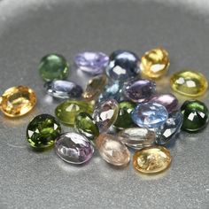 many different colored gems are on a plate and one is in the middle of it