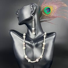 This single strand Seed Pearl and pewter Set is designed with the highest standards of craftsmanship. Expertly crafted from the finest materials, the set is composed of a blend of seed pearls and pewter, creating a timeless and elegant piece. Each set is unique and sure to elevate any outfit.* Earrings - 0.5" width, 2" drop & Weighs 0.21 oz approx.* Pendant - 0.5" width, 2" length & Weighs 0.19 oz approx.* Chain - 18" length. * Materials: Seed Pearls, Pewter* Technique: Weaving Stitches* Style: Adjustable Silver Beaded Necklace With Pearl Chain, Bohemian Pearl Necklace With Polished Beads In Silver, Bohemian Silver Pearl Necklace With Polished Beads, Elegant Pearl Spacer Beads, Artisan Silver Single Strand Jewelry, Adjustable Pearl Necklace With Silver Beads, White Metal Jewelry With Silver Beads, White Pearl Jewelry With Silver Beads, Adjustable Silver Beaded Pearl Necklace