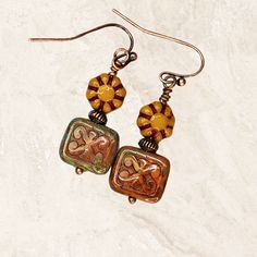 Beautiful burnt orange earrings. Richly colored Czech glass beads feature shades of orange, gold, mustard, green, dark red. Copper accents complete this Bohemian look.  Lightweight and comfortable for all day wear. Colors are trending now! Artisan glass beads produced in small quantities in the Czech Republic. Hypoallergenic ear wires (nickel and lead free). Choose ear wire style at checkout. A gift for you or someone special, earrings are carded and in an organza bag. You may also like: https:/ Artisan Orange Round Bead Earrings, Nickel-free Brown Beaded Earrings With Czech Glass, Nickel-free Brown Czech Glass Beaded Earrings, Bohemian Orange Czech Glass Earrings, Handmade Amber Earrings In Czech Glass, Vintage Orange Earrings With Czech Glass, Vintage Multicolor Czech Glass Earrings, Vintage Orange Czech Glass Earrings, Multicolor Nickel-free Copper Earrings