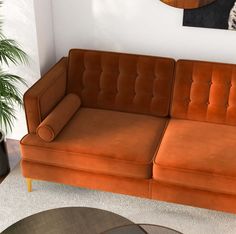 a living room with an orange couch and coffee table