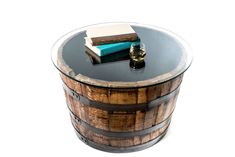 a wooden barrel table with two books on top