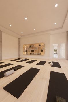 an empty room with yoga mats on the floor